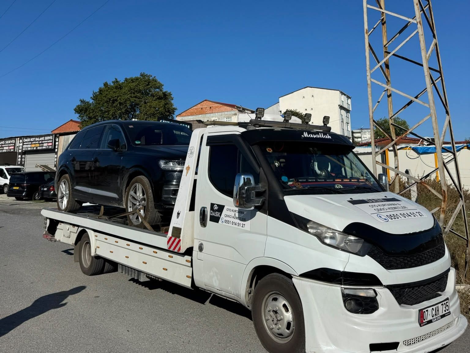Kasasında siyah SUV taşıyan Dask Oto Kurtarma çekicisi